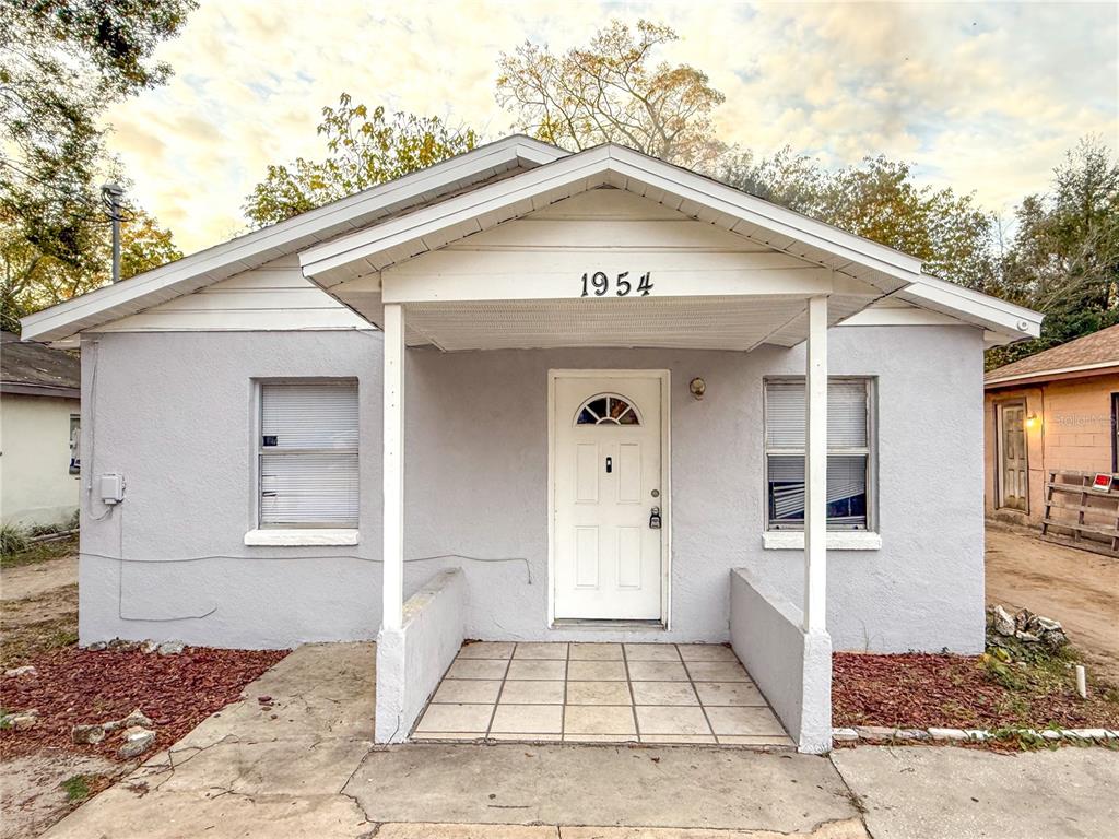 a front view of a house with white walls