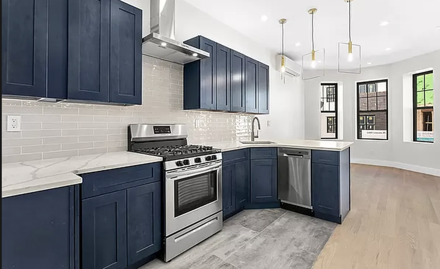 a kitchen with stainless steel appliances granite countertop a sink a stove and a wooden floors