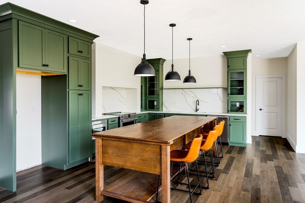 a view of kitchen island with furniture and wooden floor