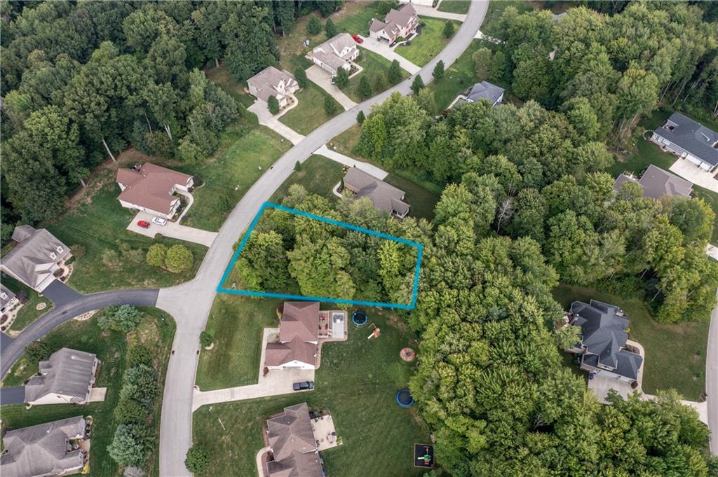 an aerial view of a house with a yard and outdoor seating