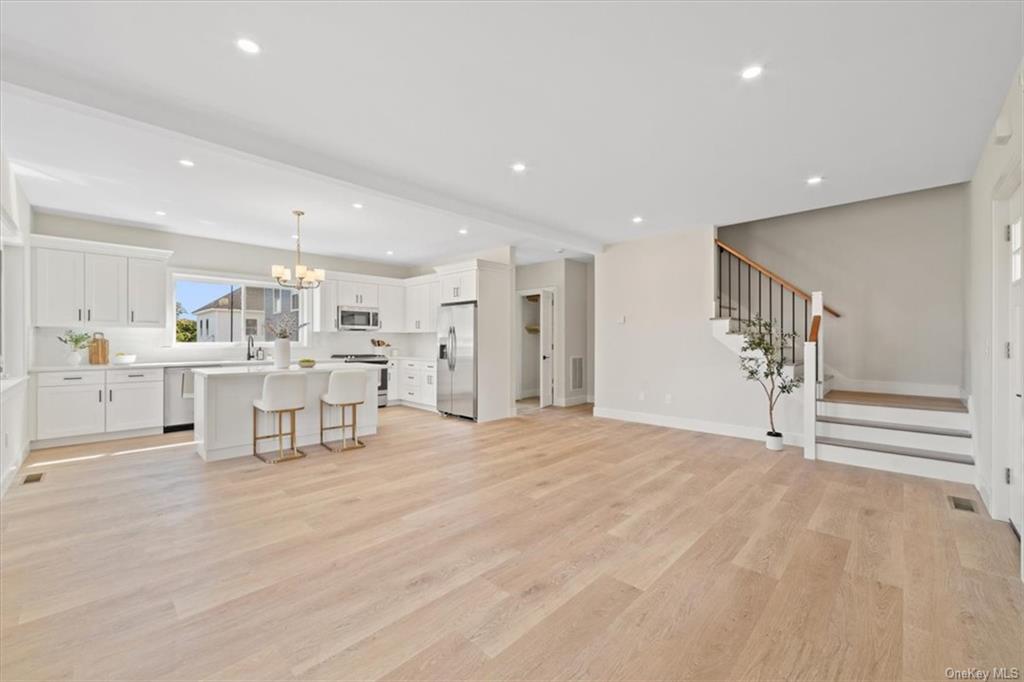 Living room featuring a chandelier, light hardwood / wood-style flooring, and sink