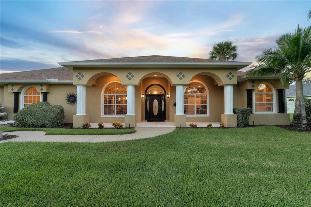 Covered grand-entry and porch at twilight