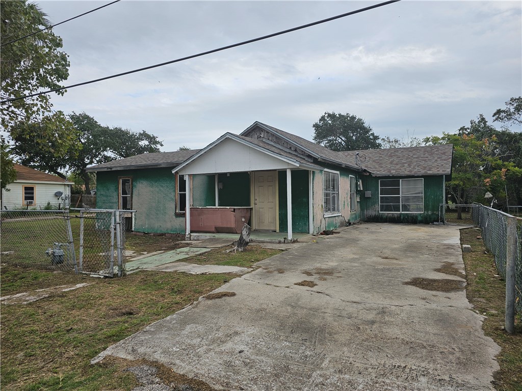 a view of a house with a yard and sitting area