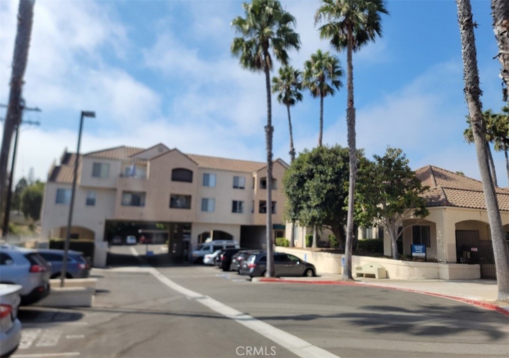 a view of a street with cars parked