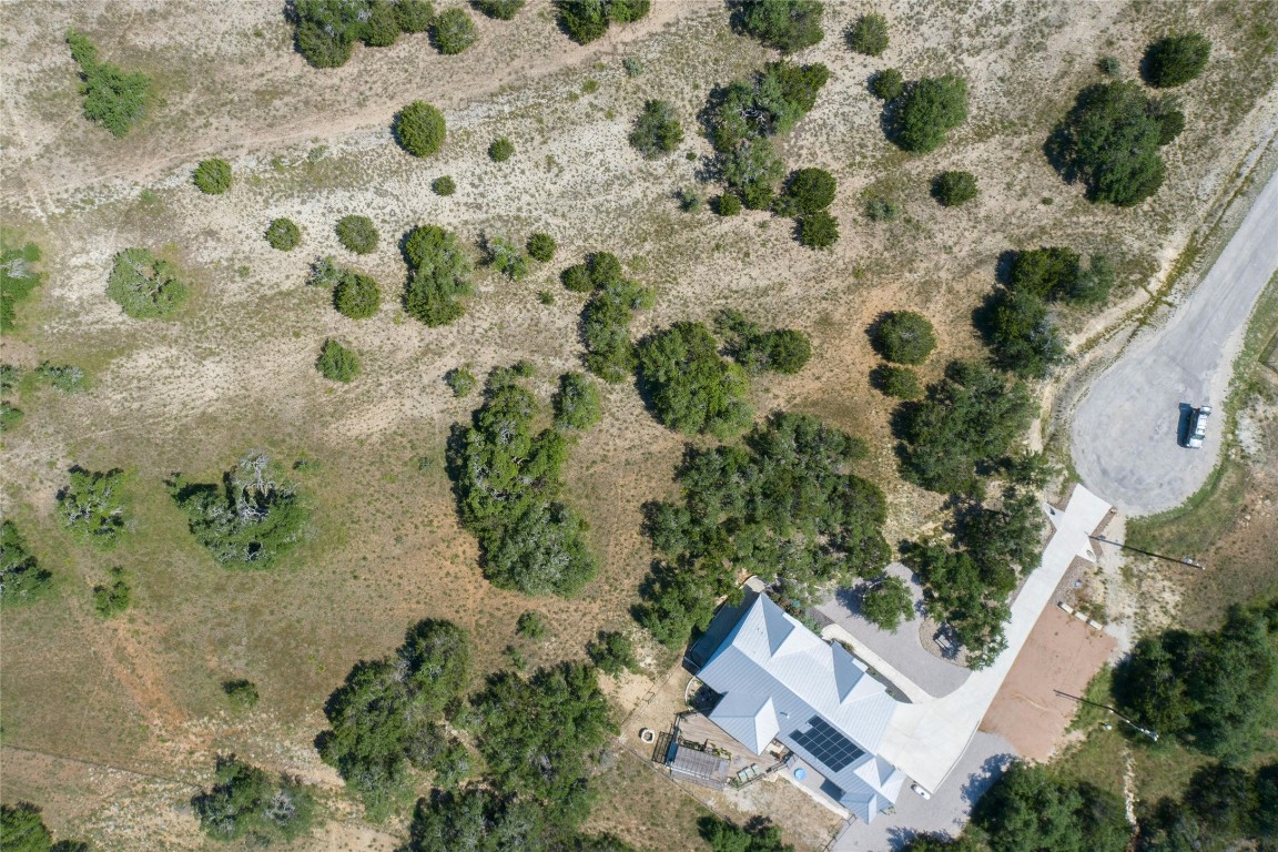 an aerial view of a house with a yard