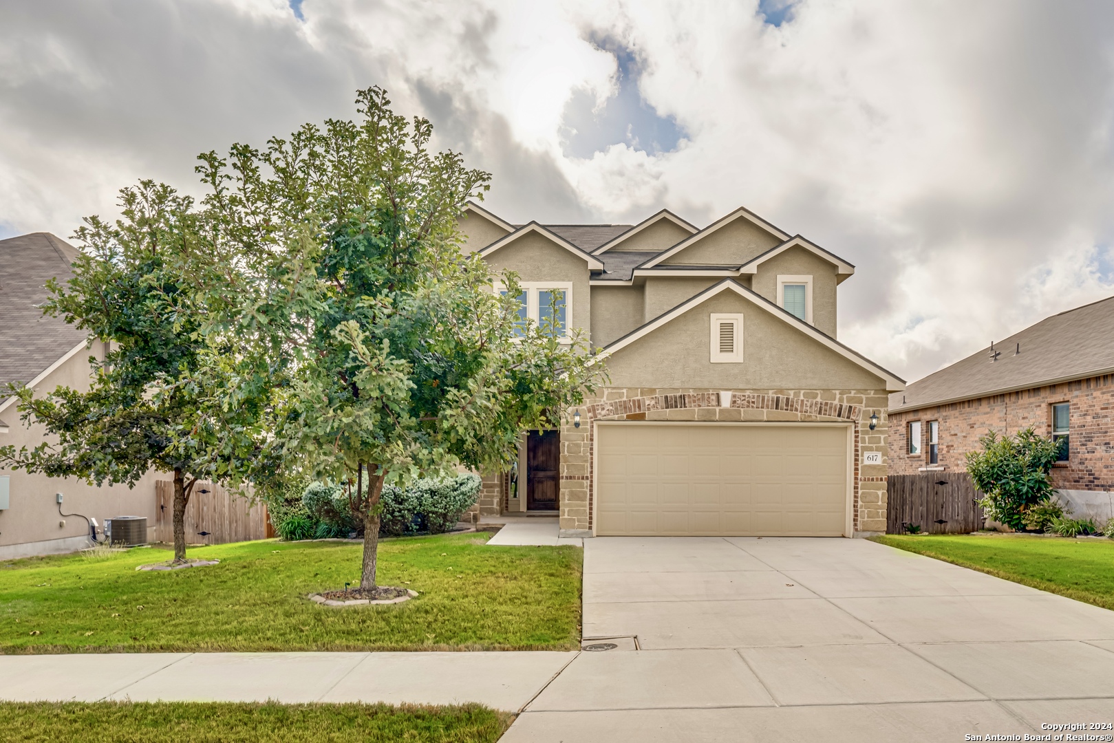 a front view of a house with a yard and garage