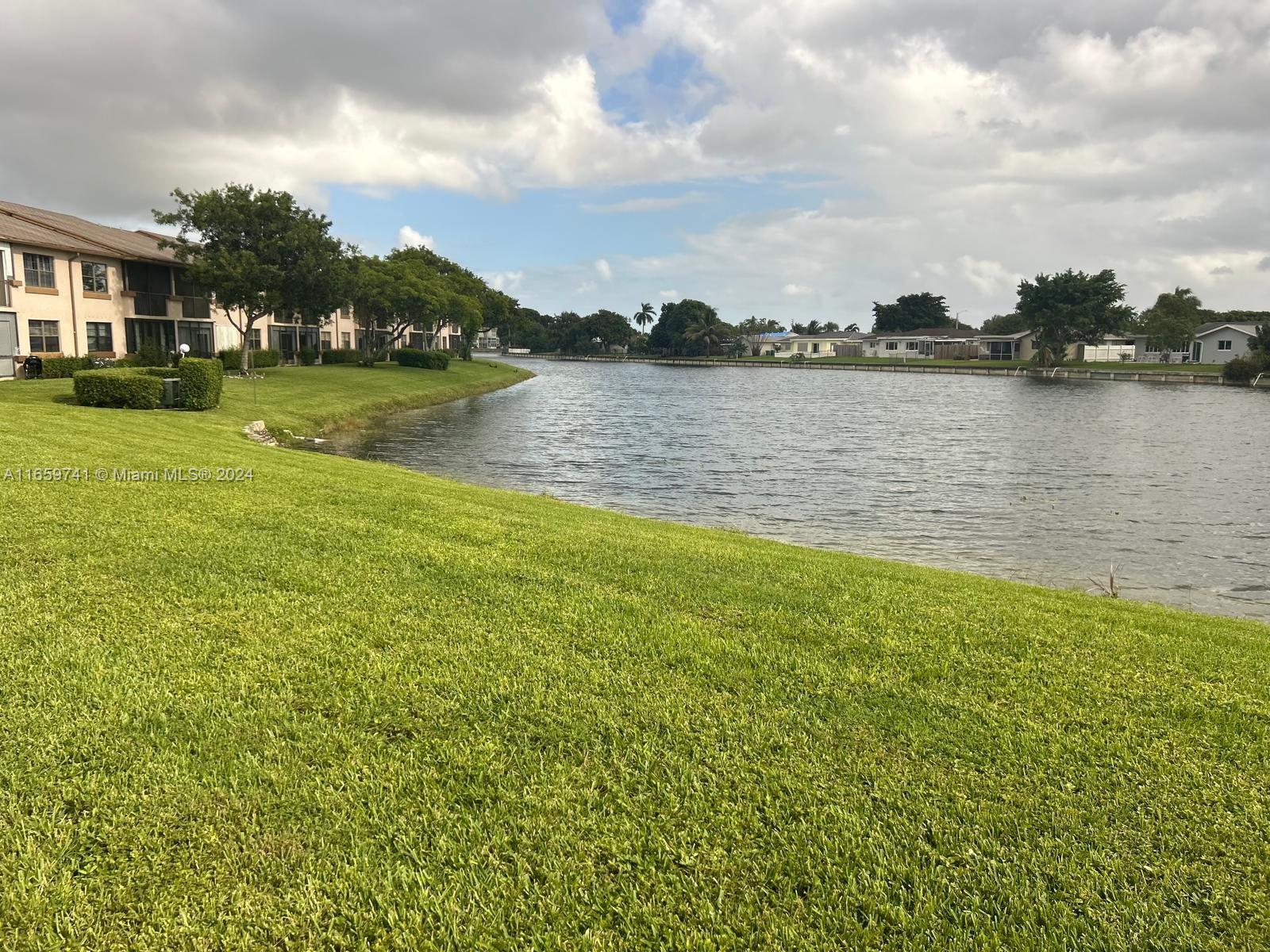 a view of a lake with houses in the back