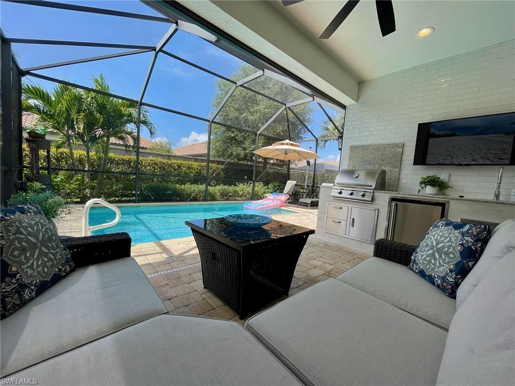 a living room with patio furniture and a garden