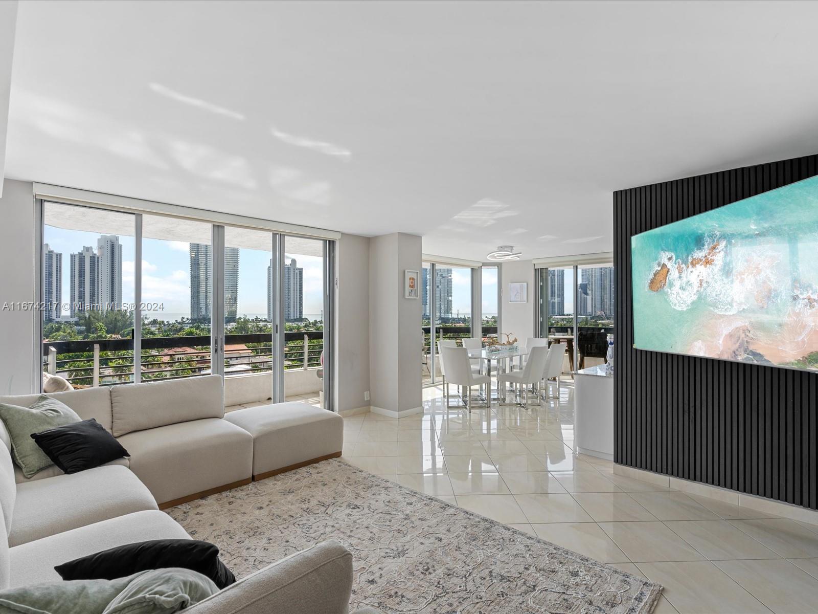 a living room with furniture large window and flat screen tv