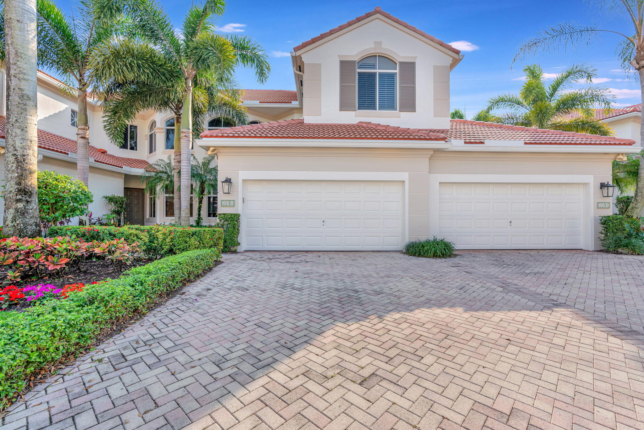 a front view of a house with a yard and a garage