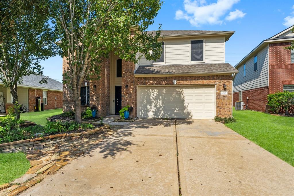 a front view of a house with a yard and a garage