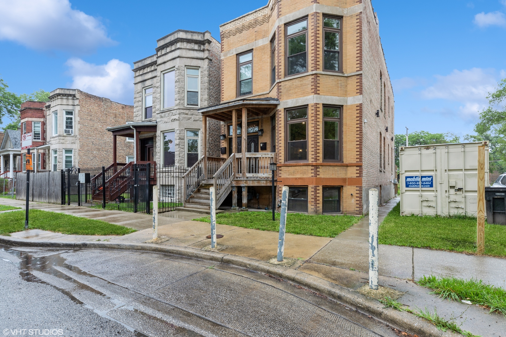 a view of a brick house next to a yard