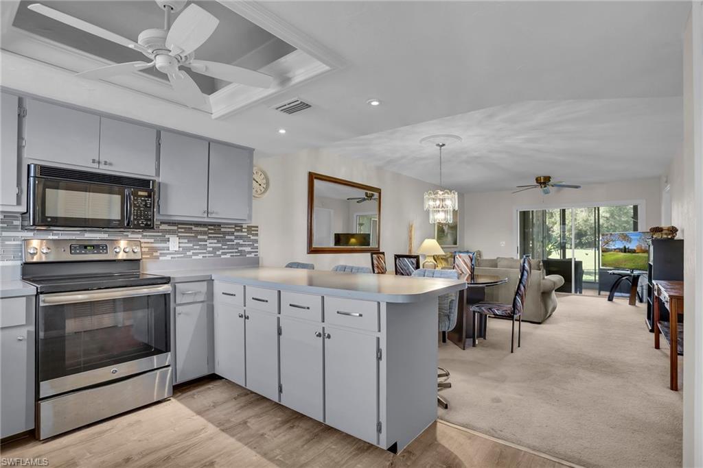 a kitchen with sink stove and cabinets