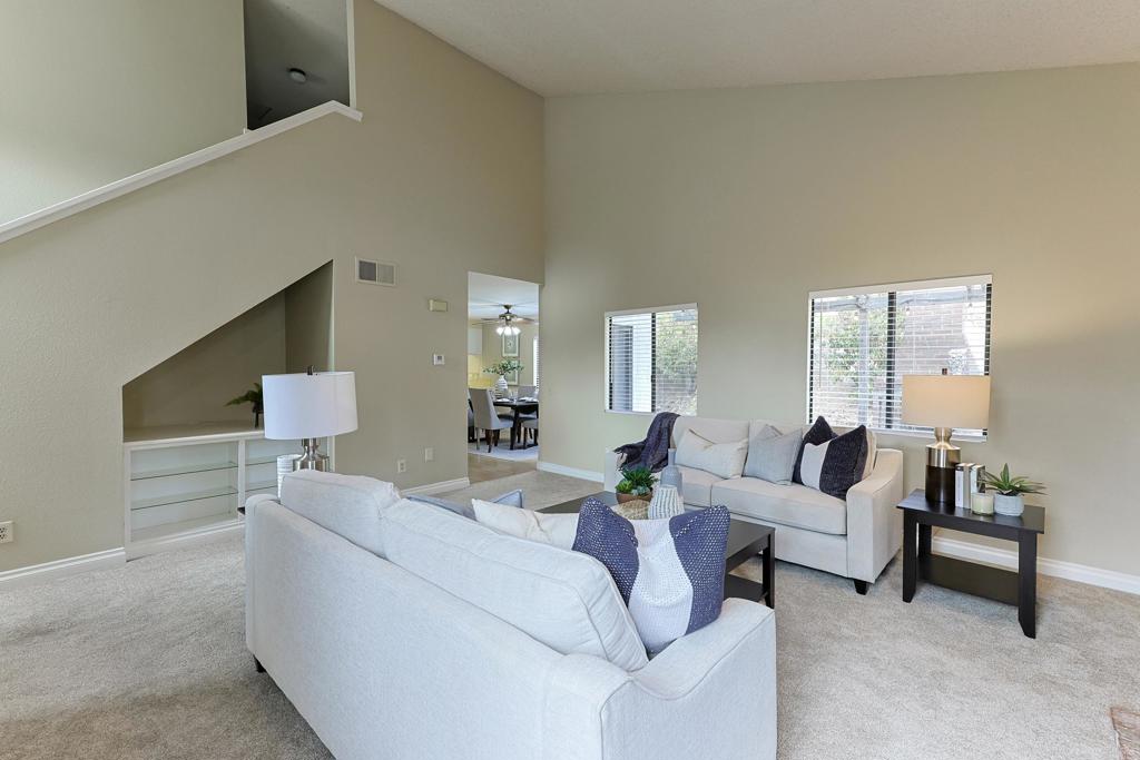 a living room with furniture and a potted plant