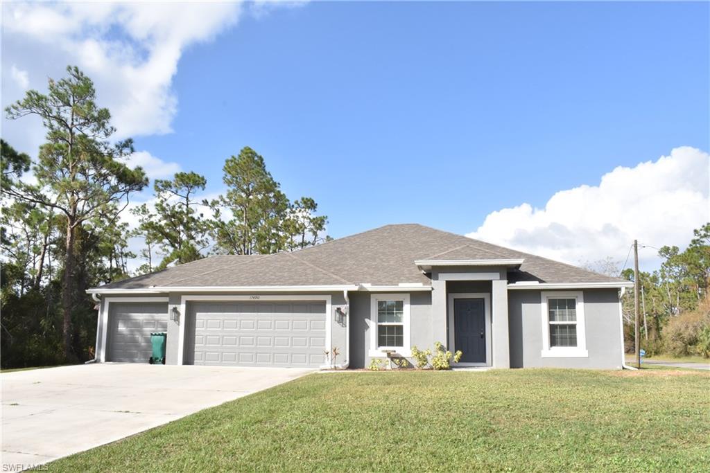 View of front of home with a garage and a front yard