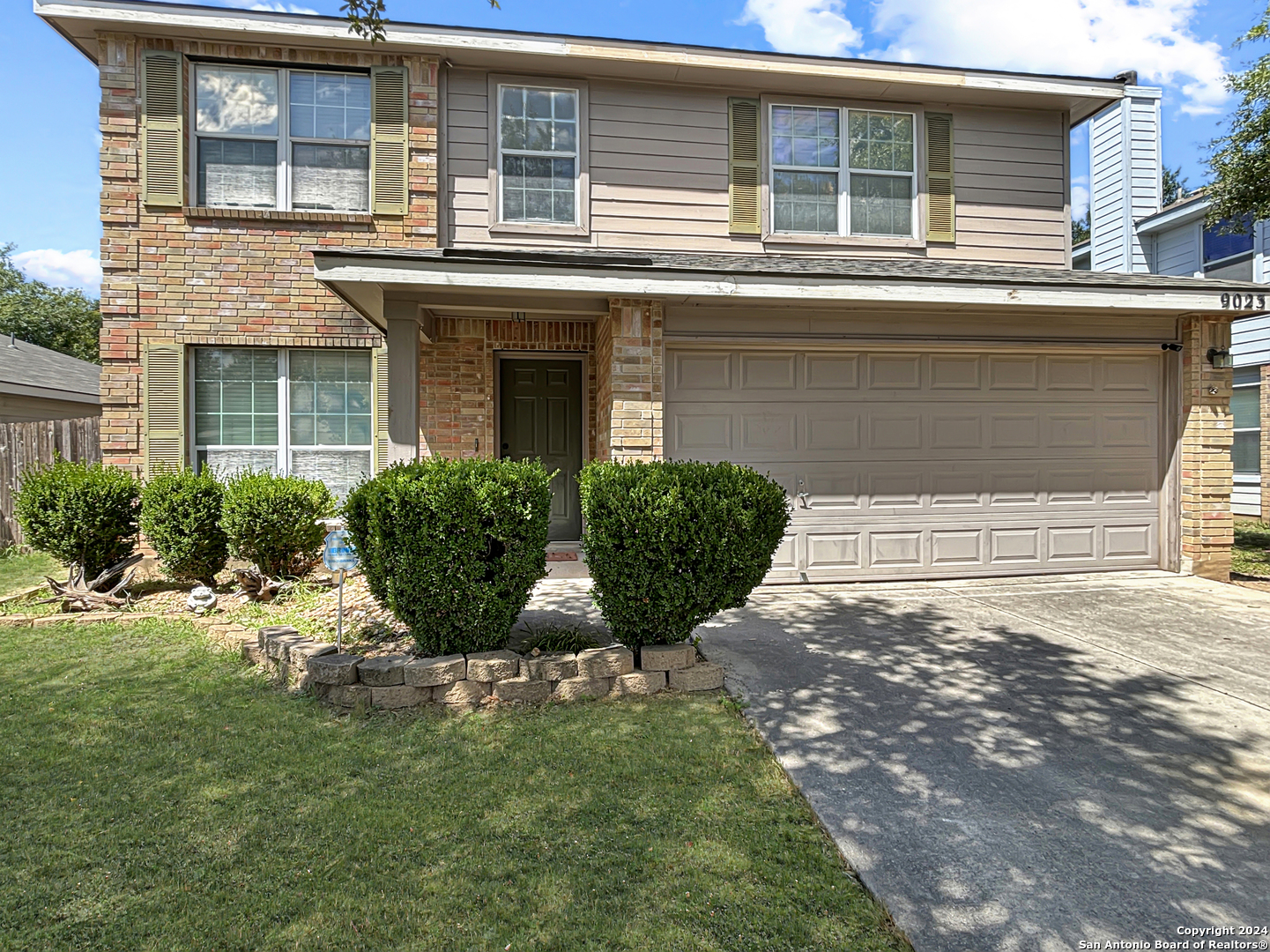 front view of a house with a yard