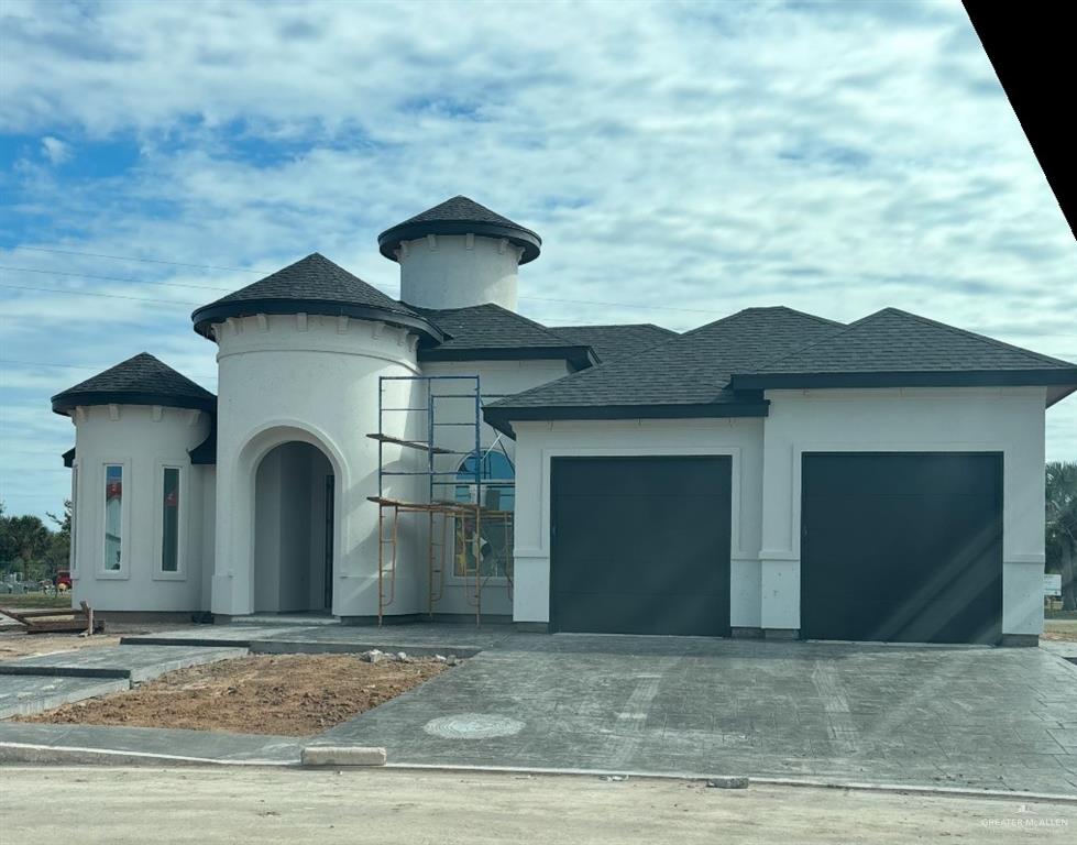 View of front facade featuring a garage