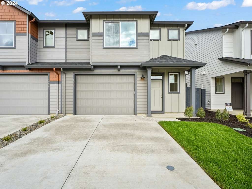 a front view of a house with a yard and garage