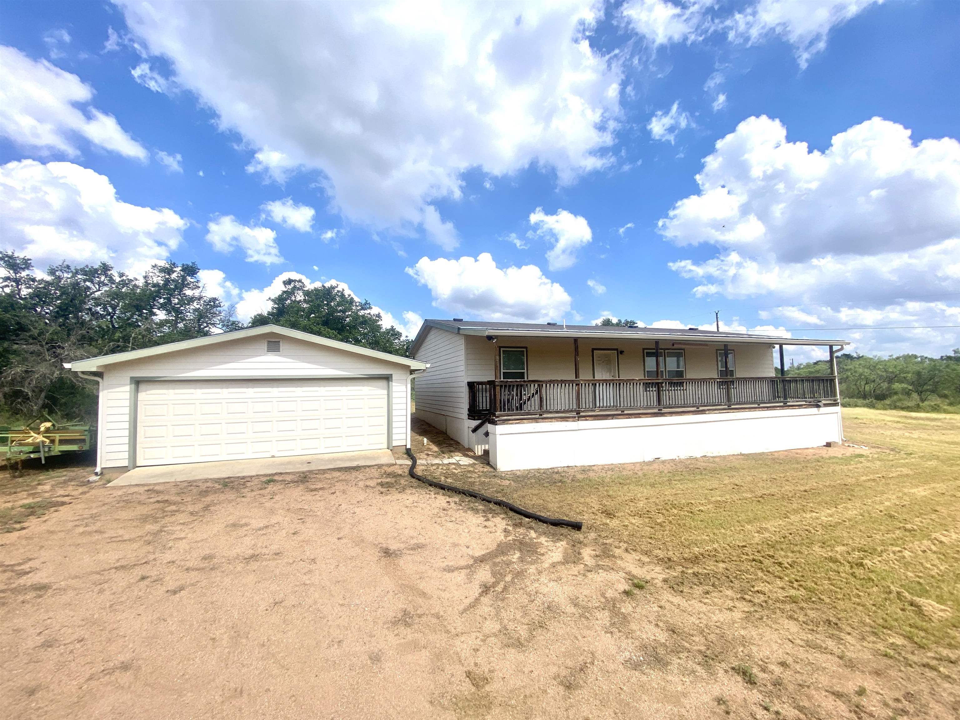 a view of a house with a yard and garage