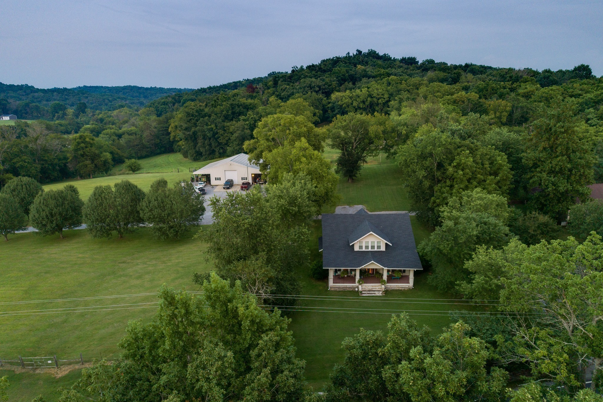 an aerial view of a house with a garden and a yard