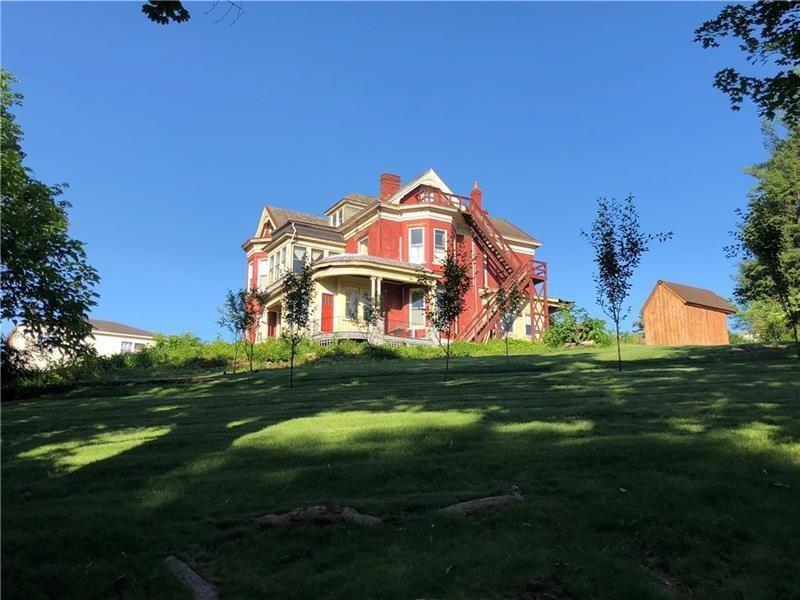 a view of a big house with a big yard