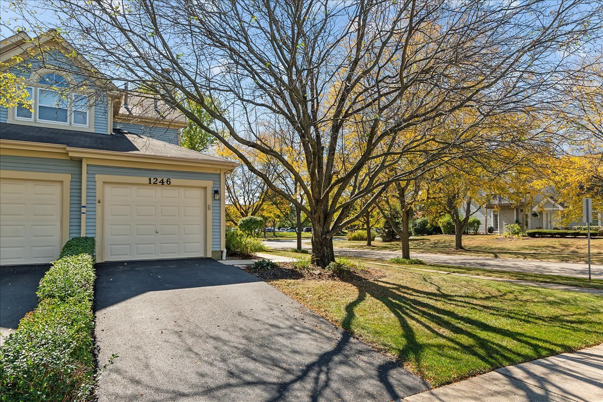 a view of a house with a yard and garage