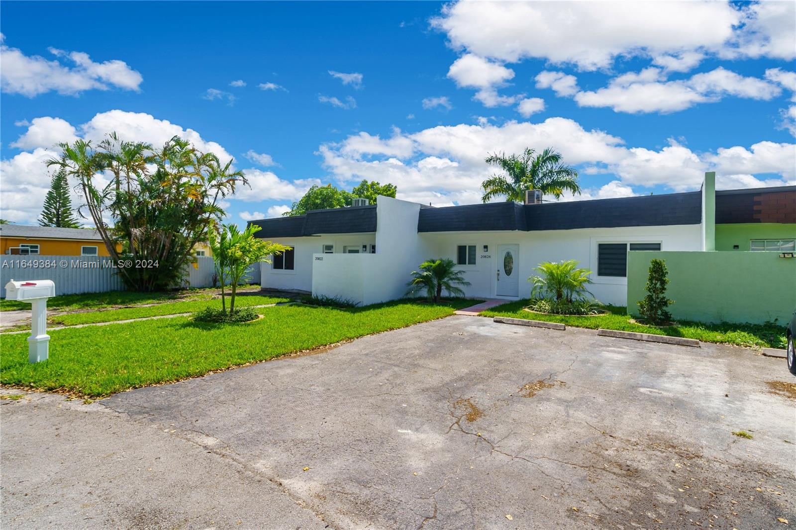 a front view of a house with a yard and a garage