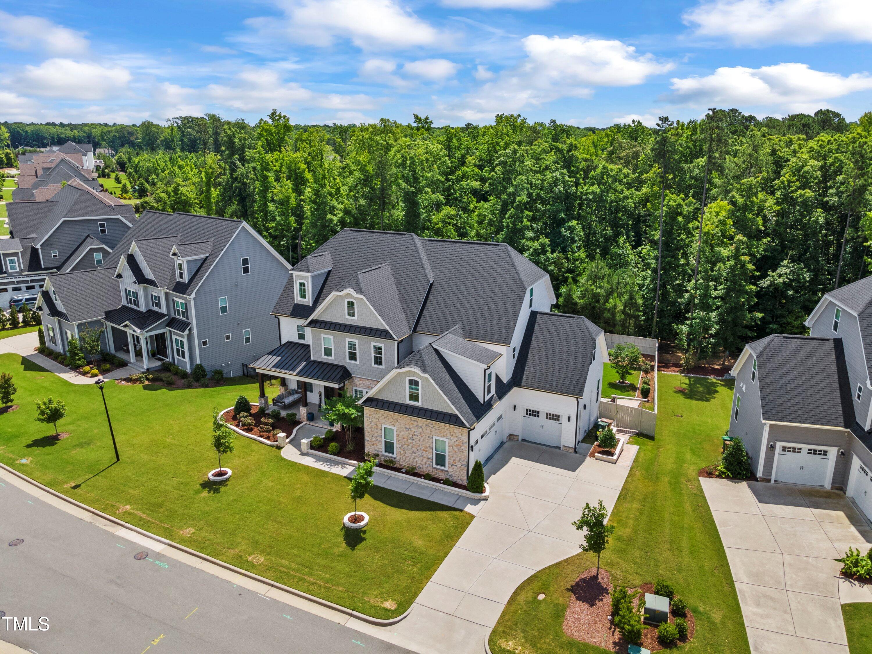 an aerial view of a house with garden space and outdoor seating