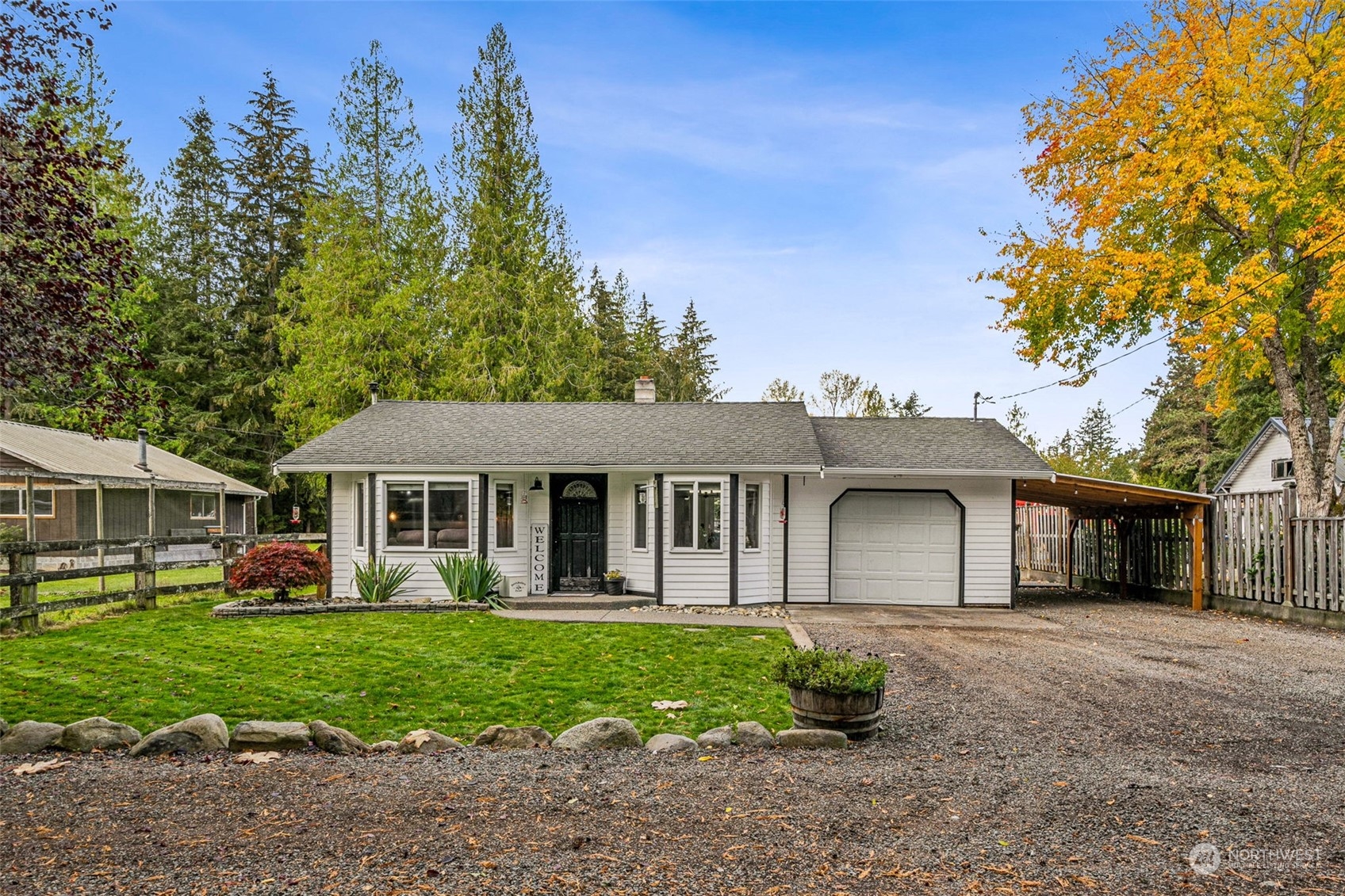 a front view of a house with a garden and yard