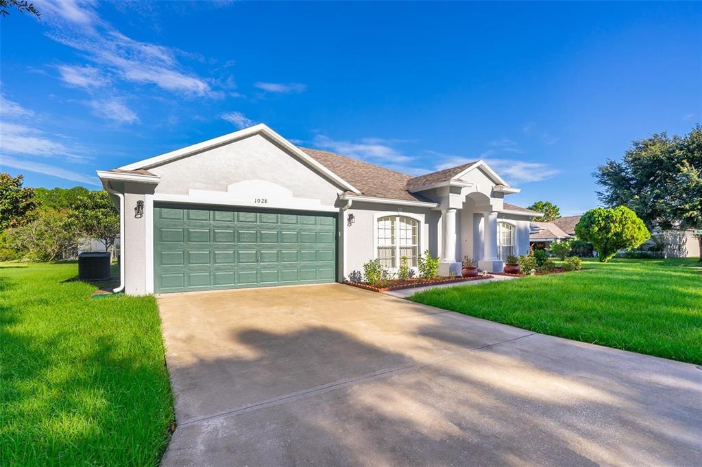 a front view of a house with a yard and garage