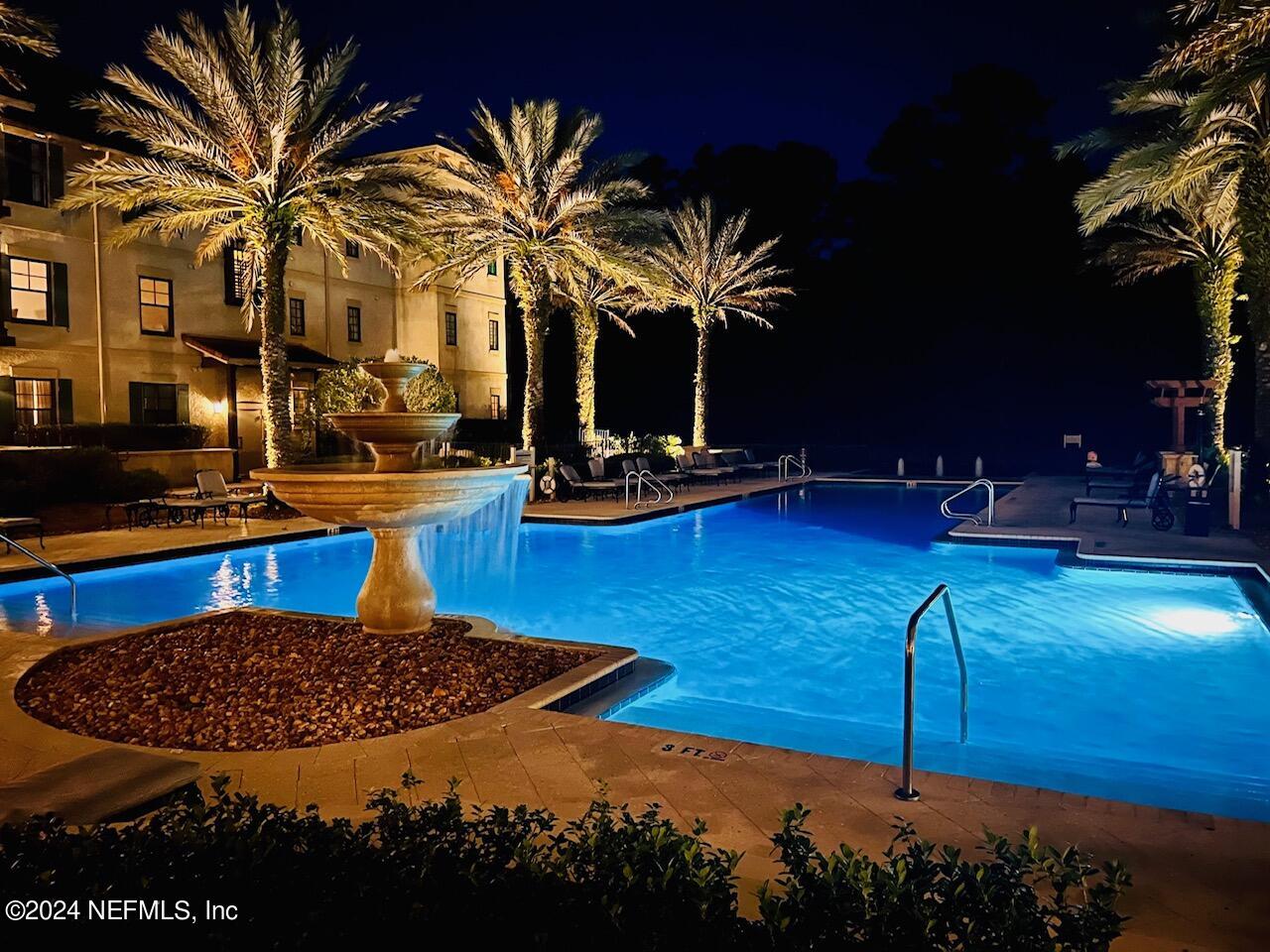 a view of a swimming pool with a table and chairs