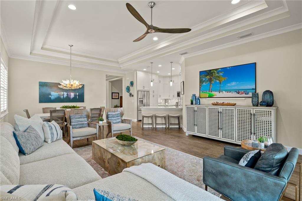 a living room with furniture a rug and a flat screen tv