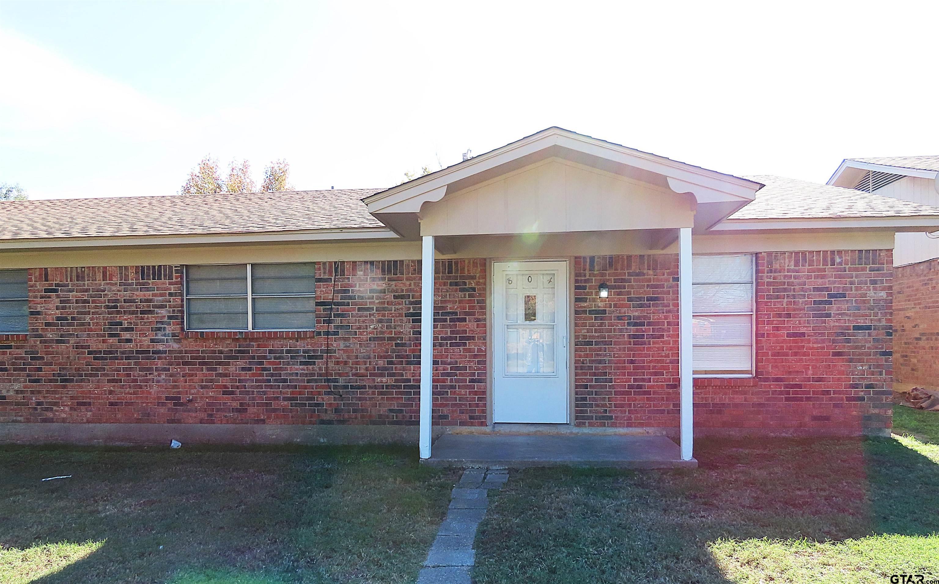 a front view of a house with brick walls