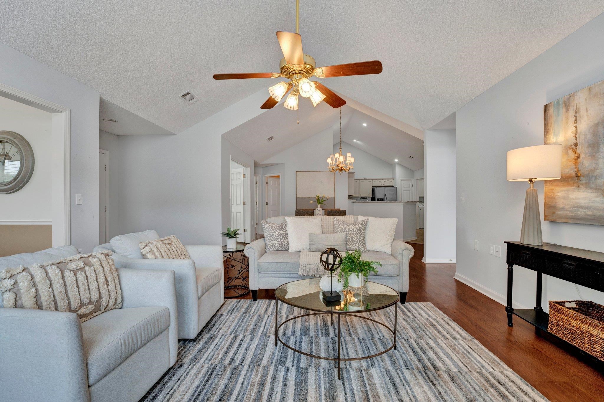 a living room with furniture and a wooden floor