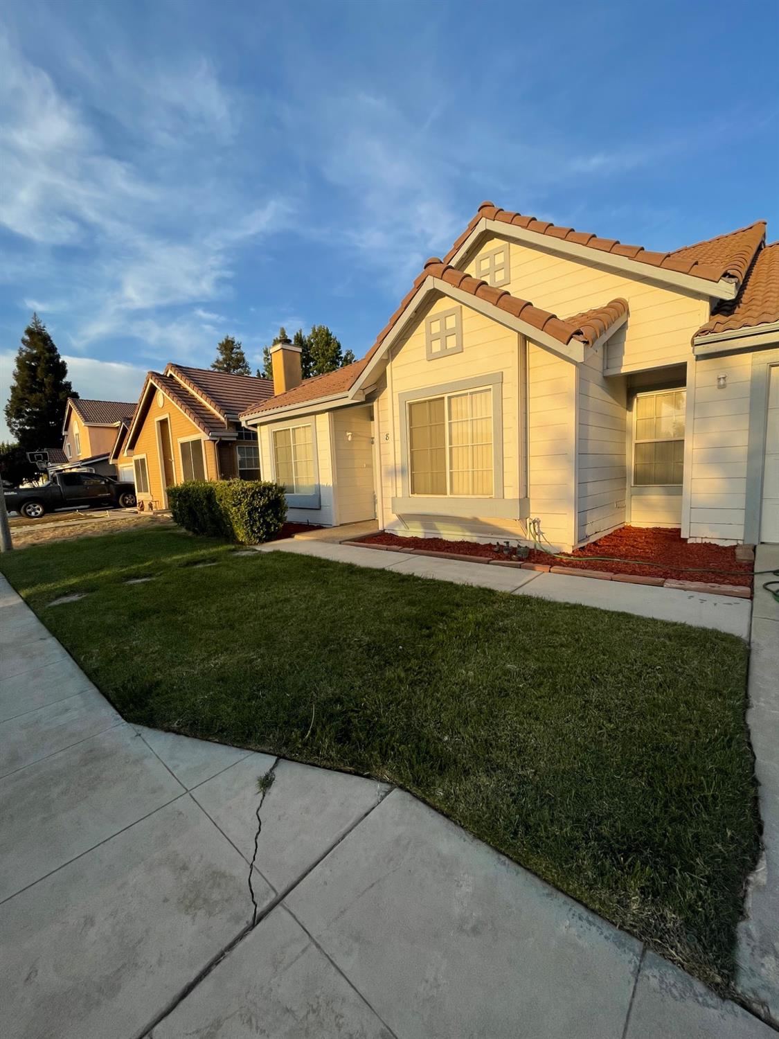 a view of a big house with a big yard and plants