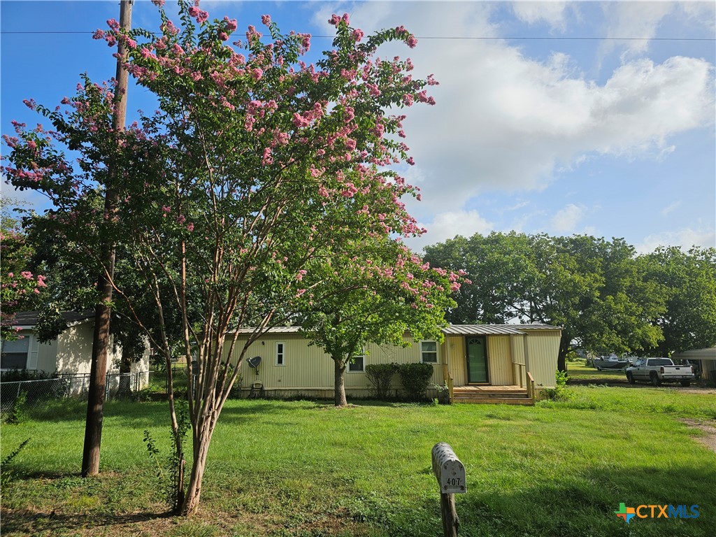 a backyard of a house with lots of green space and fountain