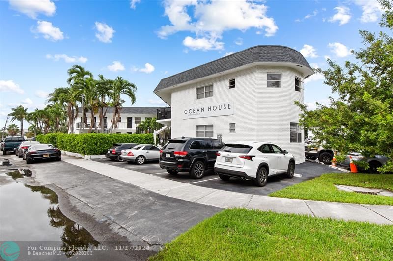 a view of a cars park in front of a house