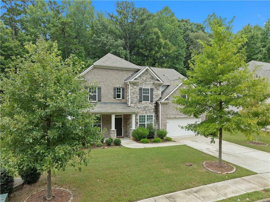 a front view of a house with a yard