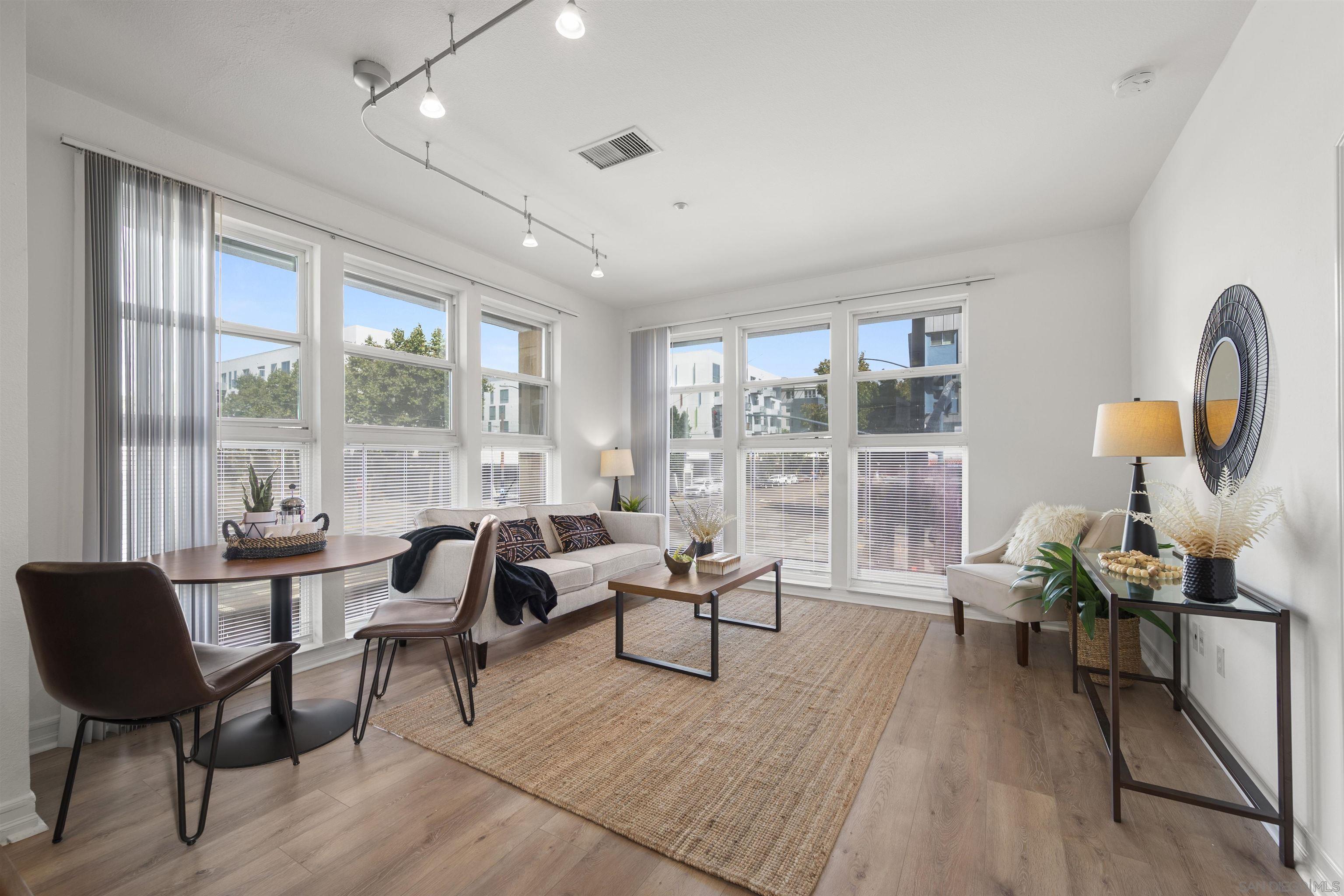 a living room with furniture and a potted plant