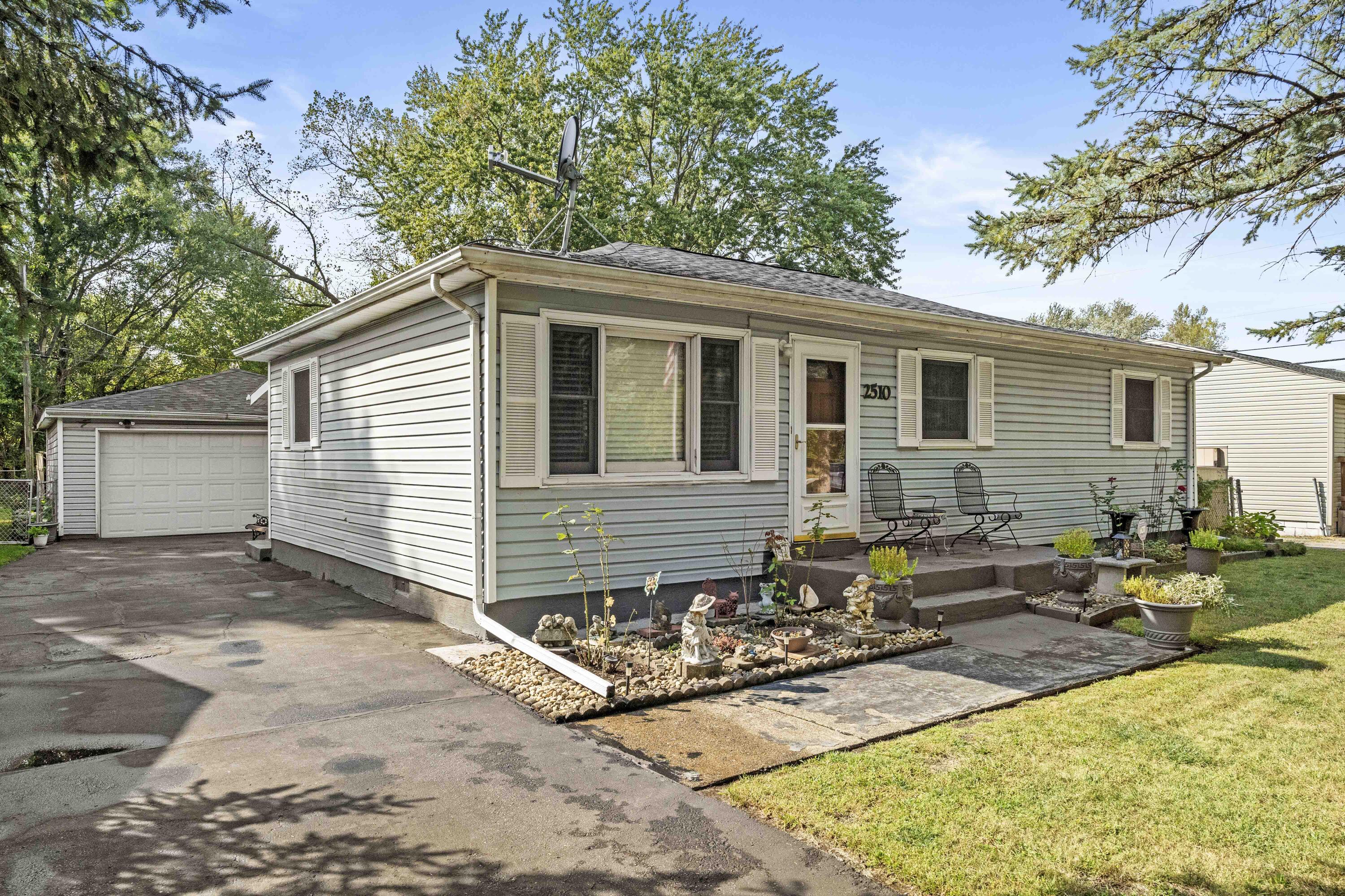 a view of a house with yard and sitting area