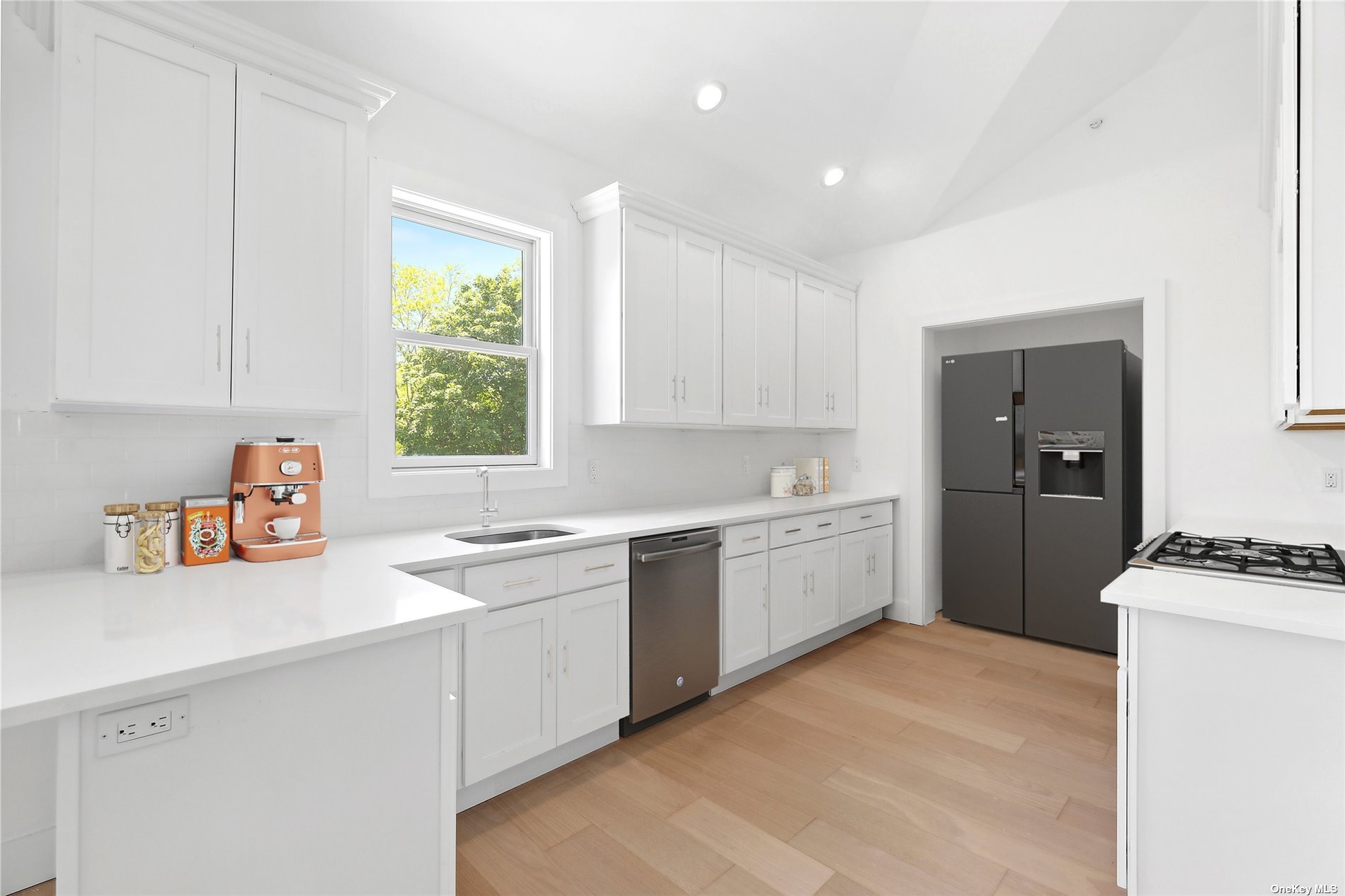 a kitchen with a white cabinets and white appliances