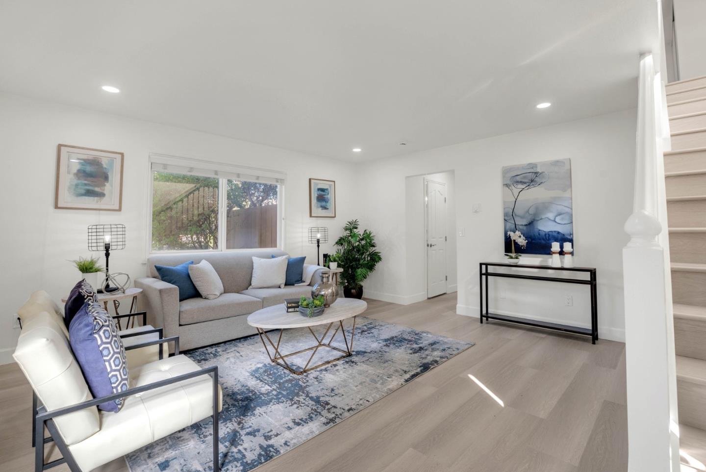 a living room with furniture and a potted plant