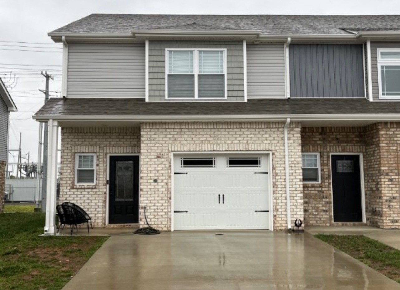 a view of a house with more windows and a yard