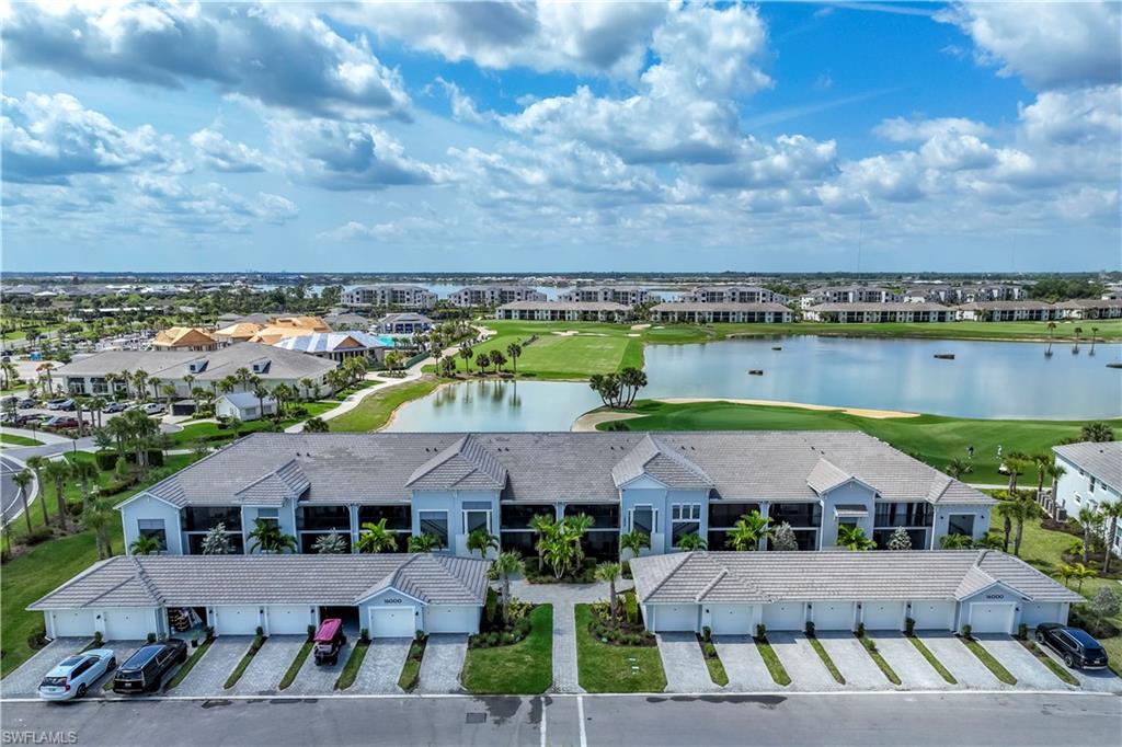 an aerial view of multiple houses with a swimming pool