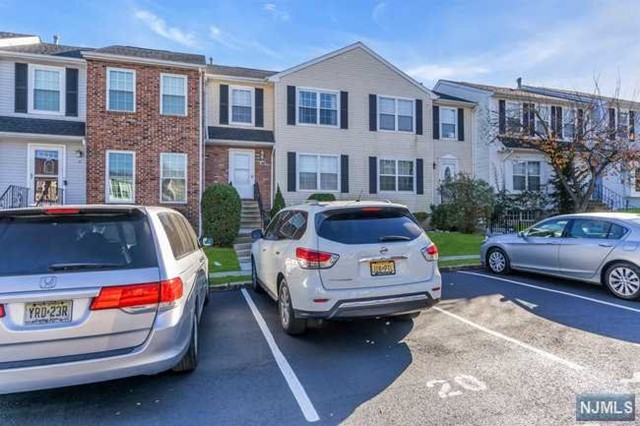 a front view of a house with parking space