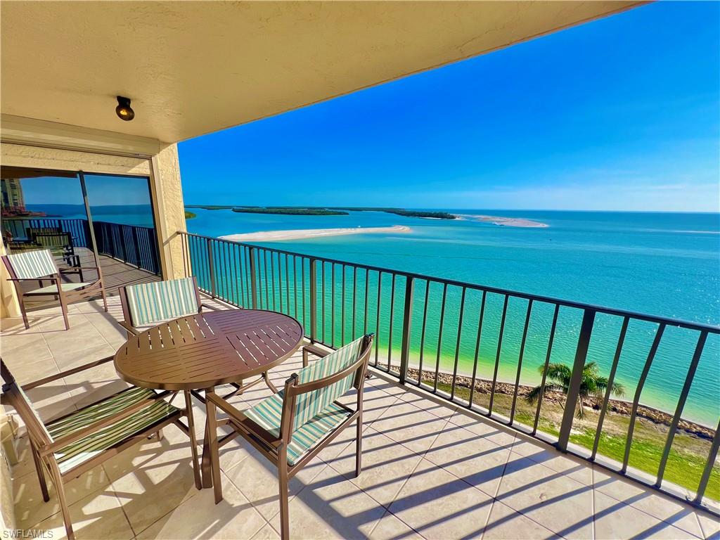 a view of balcony with table and chairs