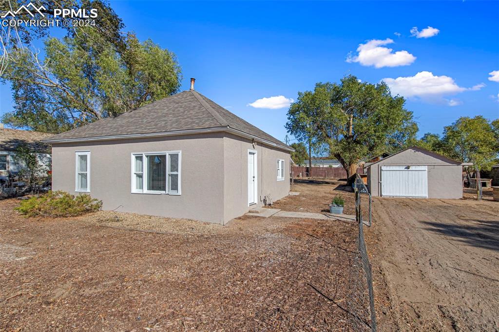 View of home's exterior featuring a storage shed