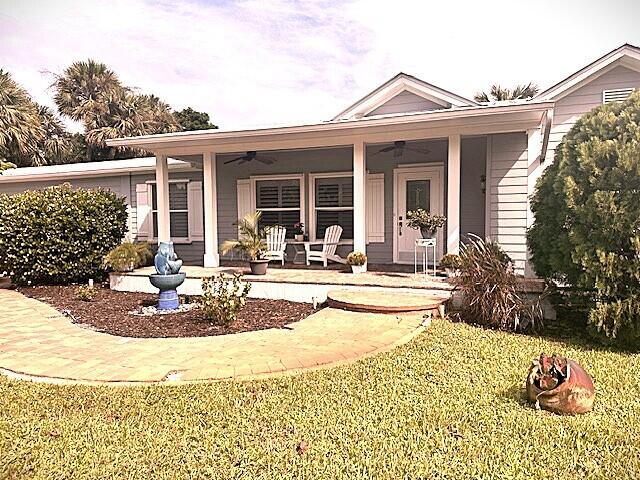 a view of a house with swimming pool and sitting area