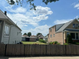 a view of a house with a wooden fence