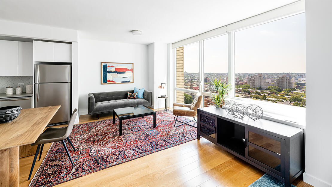 a living room with furniture water view and large windows